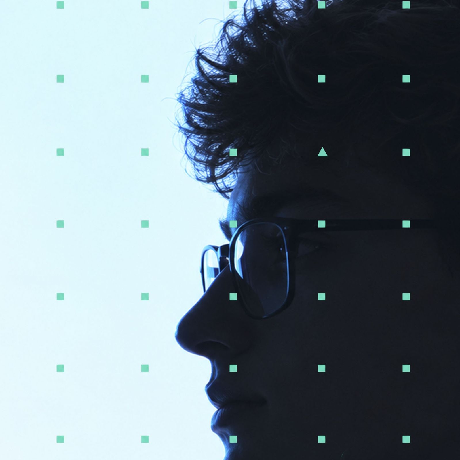 Profile of a teenager in glasses against a pale sky with the UP'N'FAME dot grid